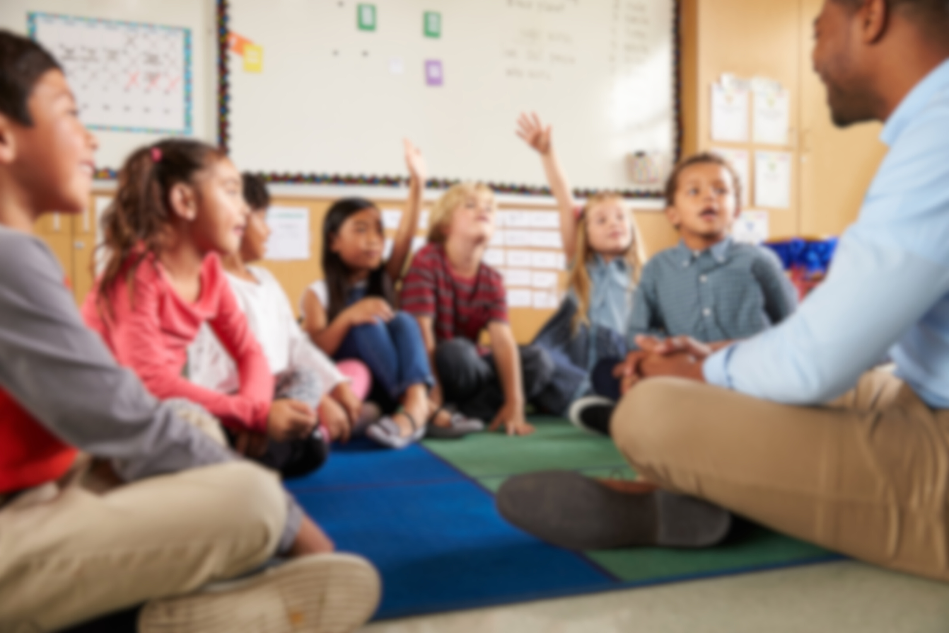 students in class raise hands - illustrative image for dual language immersion program