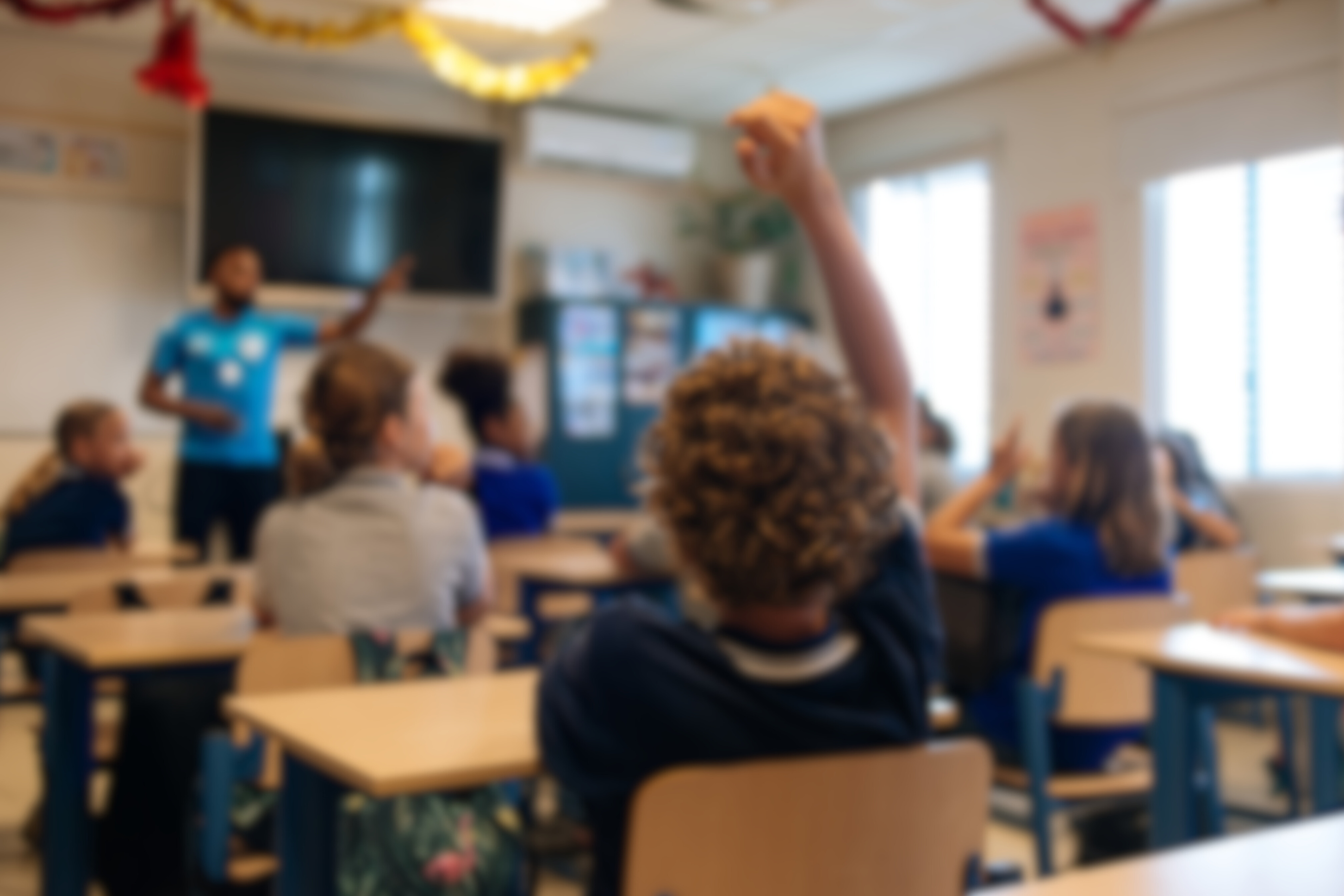student raises hand in middle school classroom - illustrative image for MTSSB promo