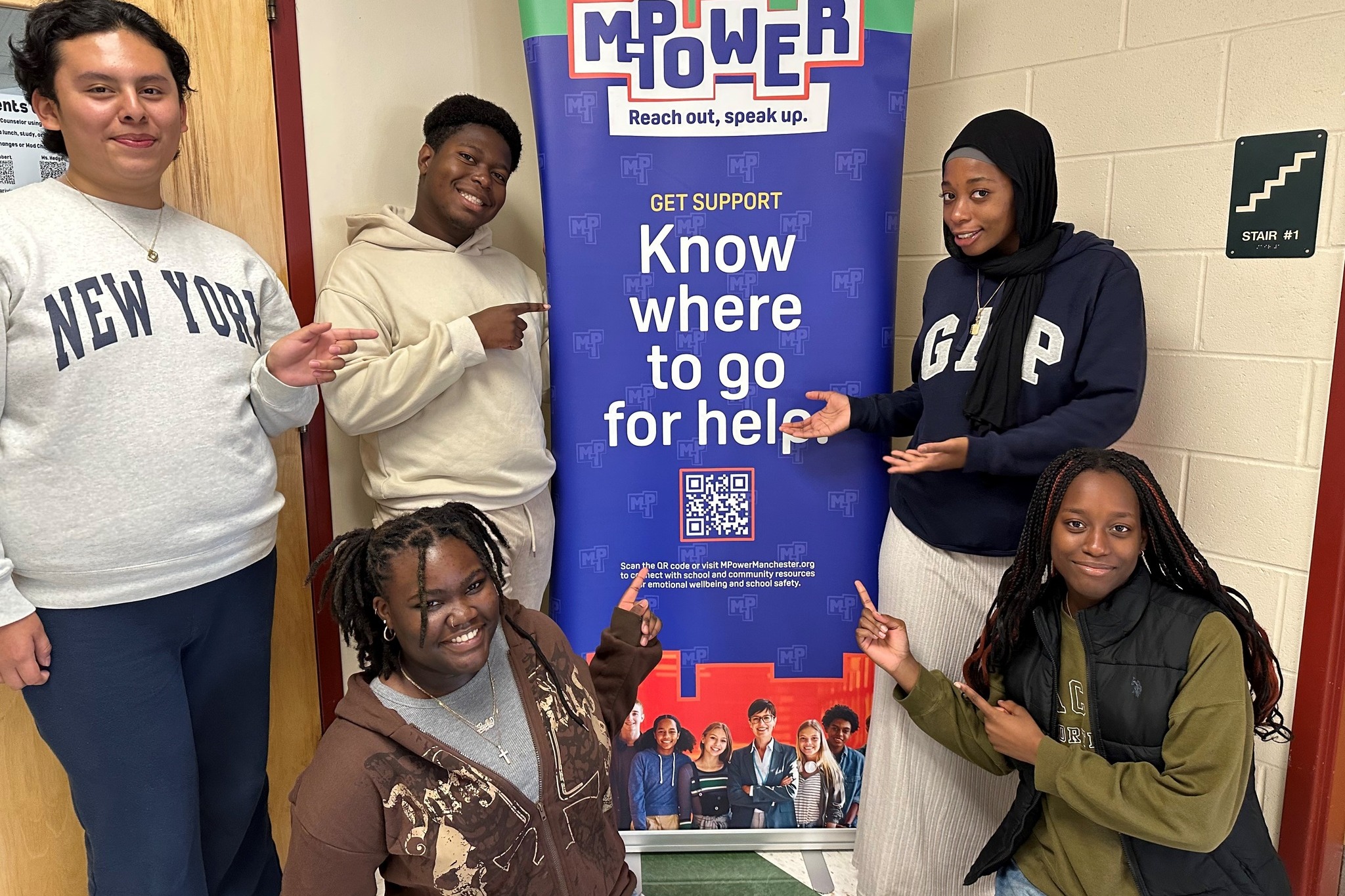 students at Central show off M-Power sign