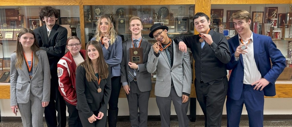 forensics squad holds up medals won at the Lyndon High School tournament