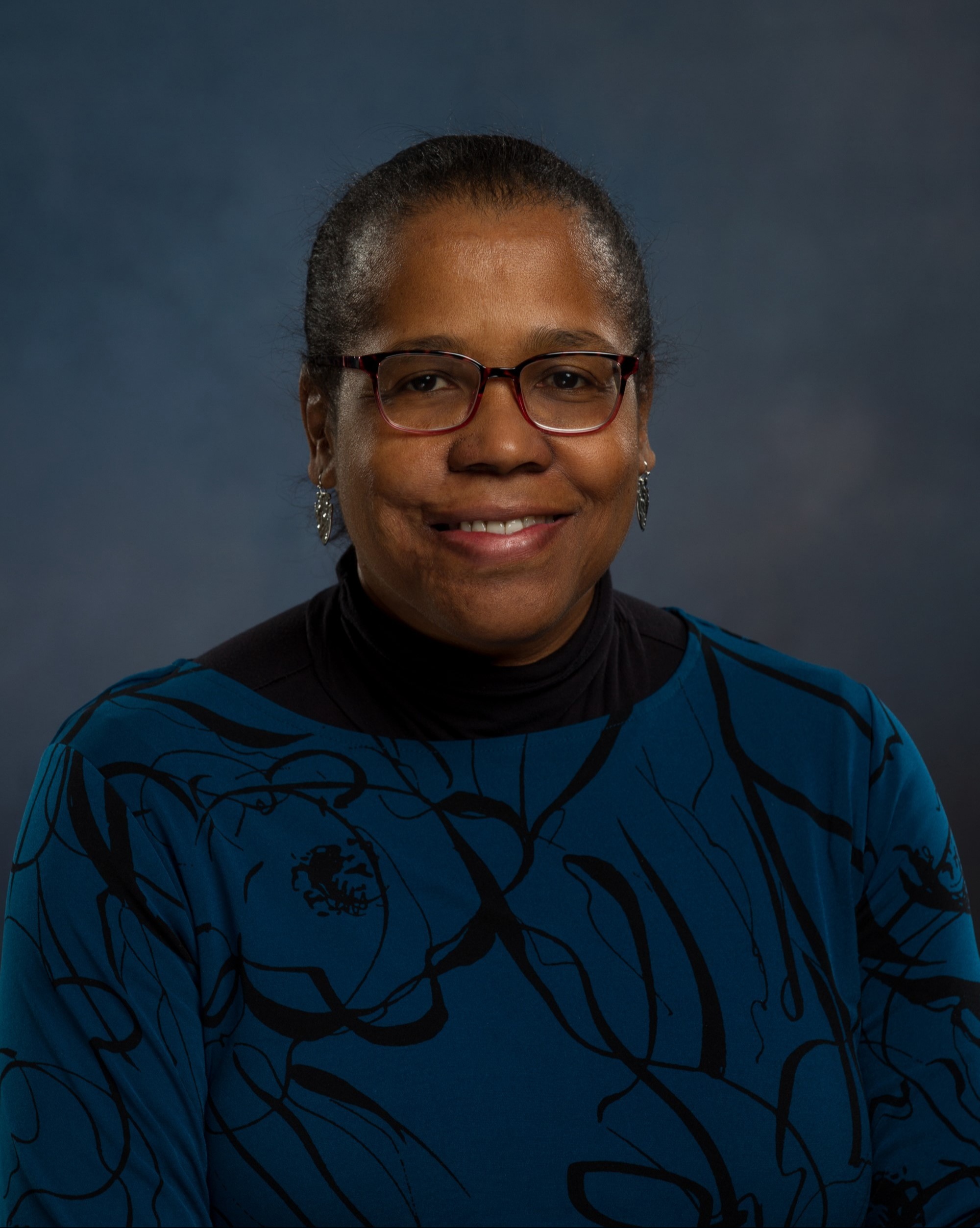 Karen Bottary headshot wearing dark green blue sweater