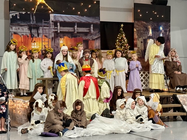 students dressed up on stage for nativity play 