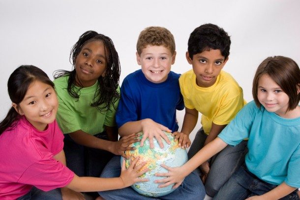 5 various-raced students touching a globe