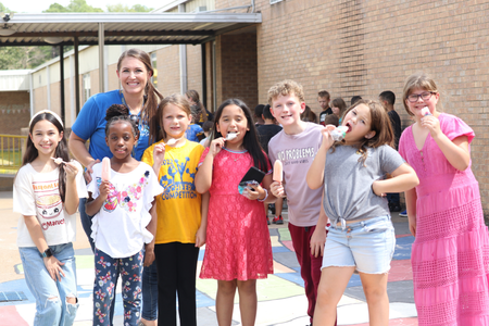 a principal with students eating popsicles