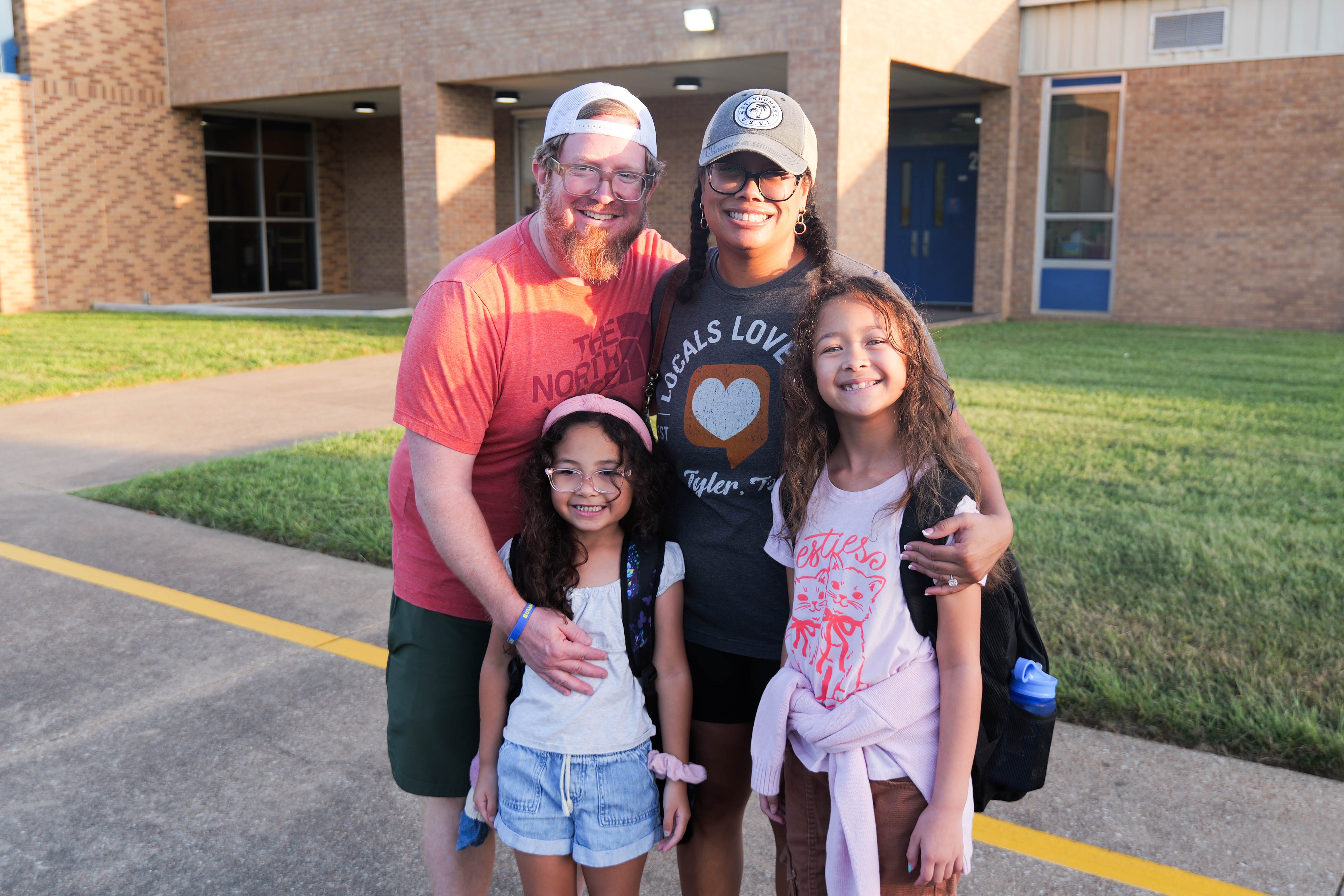 a family gathered out front of Wise Elementary for the first day of school