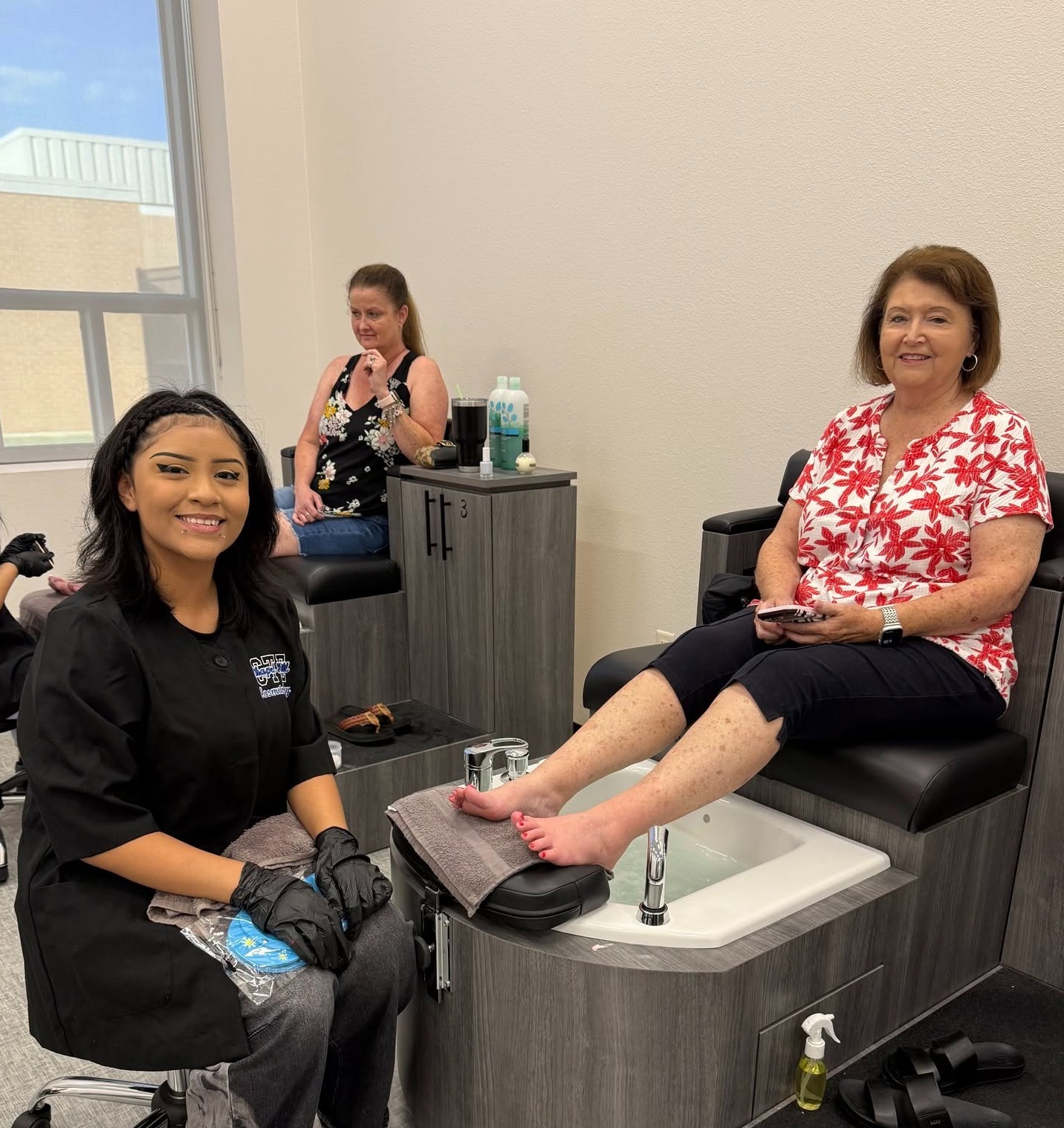 a student gives a community member a pedicure