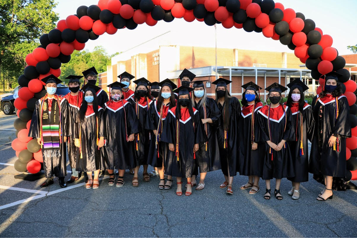 group of students on graduation day wearing traditional graduation caps and gowns