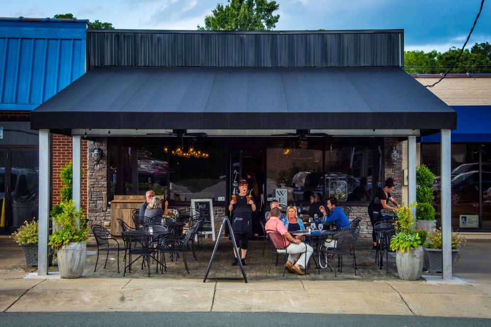 Photograph of people sitting outside at the restaurant 2Twelve in Mebane