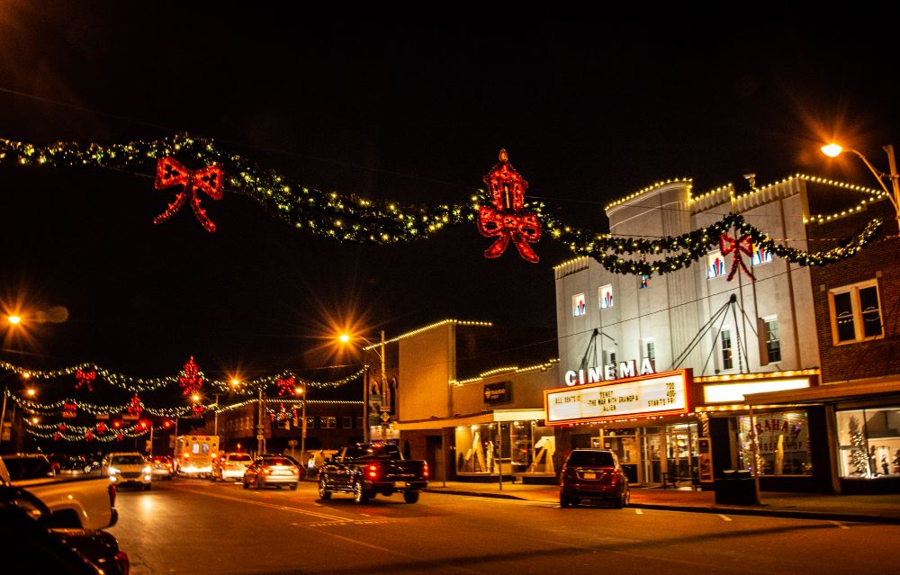 Photograph of downtown Graham at night with holiday lights strung up between buildings