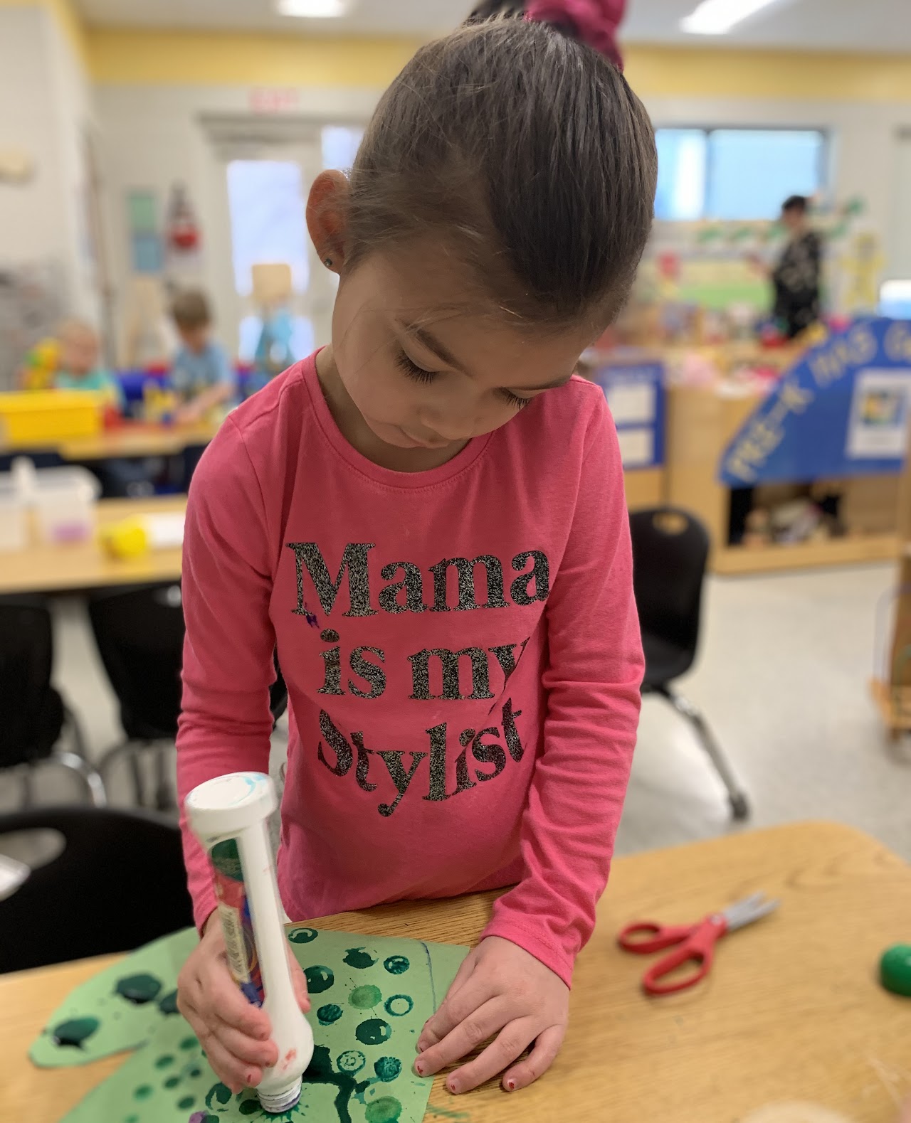 Pre-K student making a craft