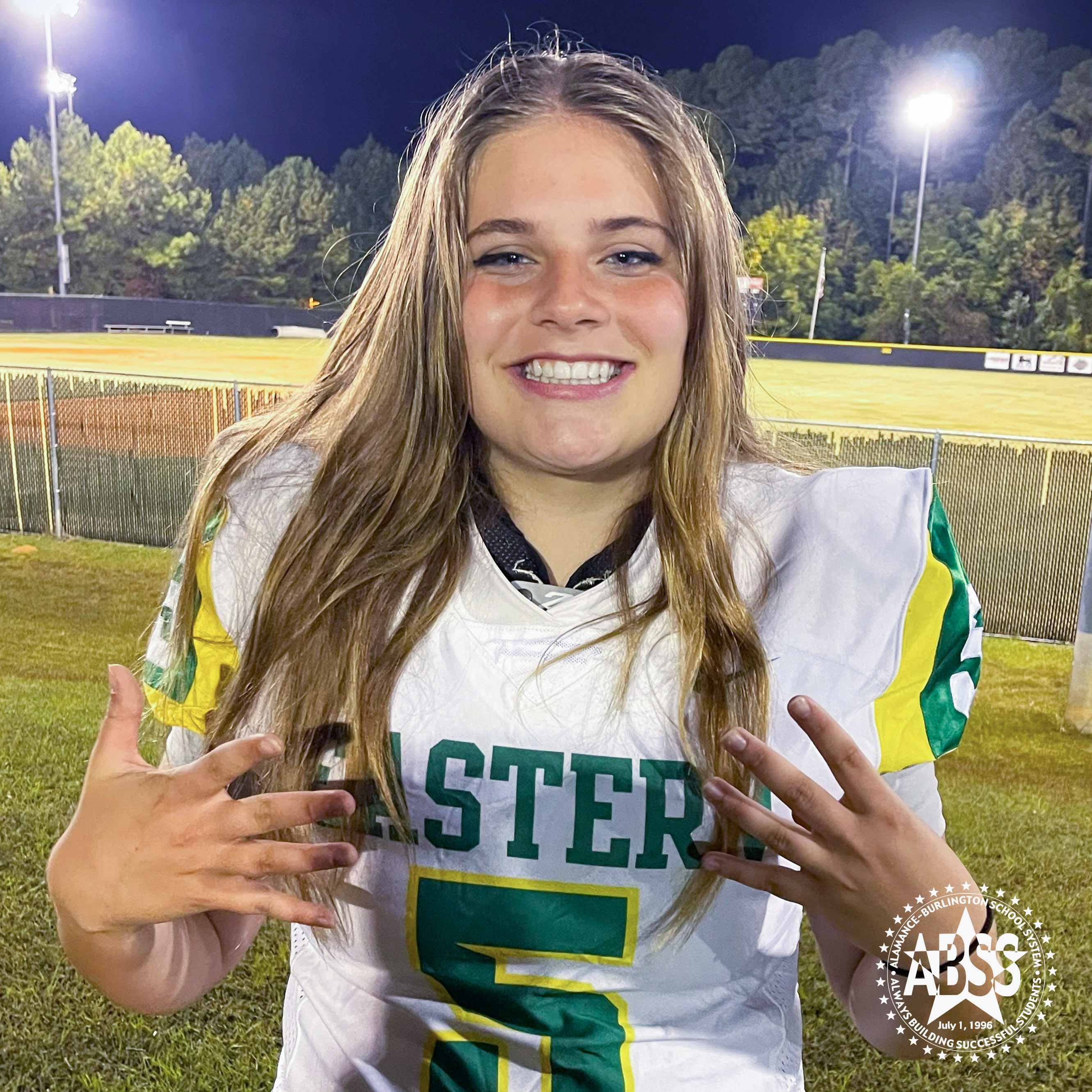 Photograph of Eastern Alamance High School kicker Karsyn Johnson wearing her jersey and smiling at the camera
