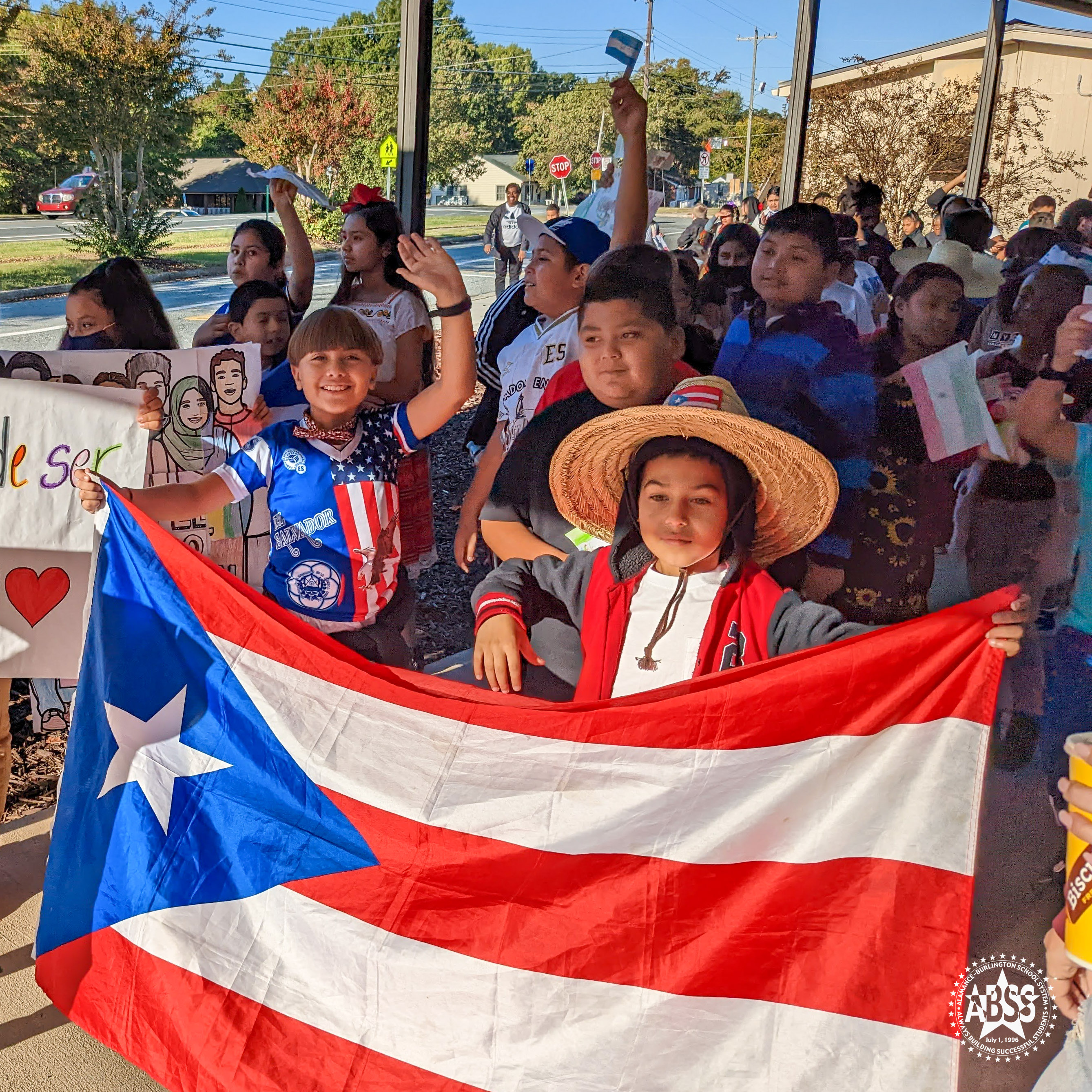 Students from Eastlawn Elementary holding a Puerto Rico flag as part of Hispanic Heritagre month parade