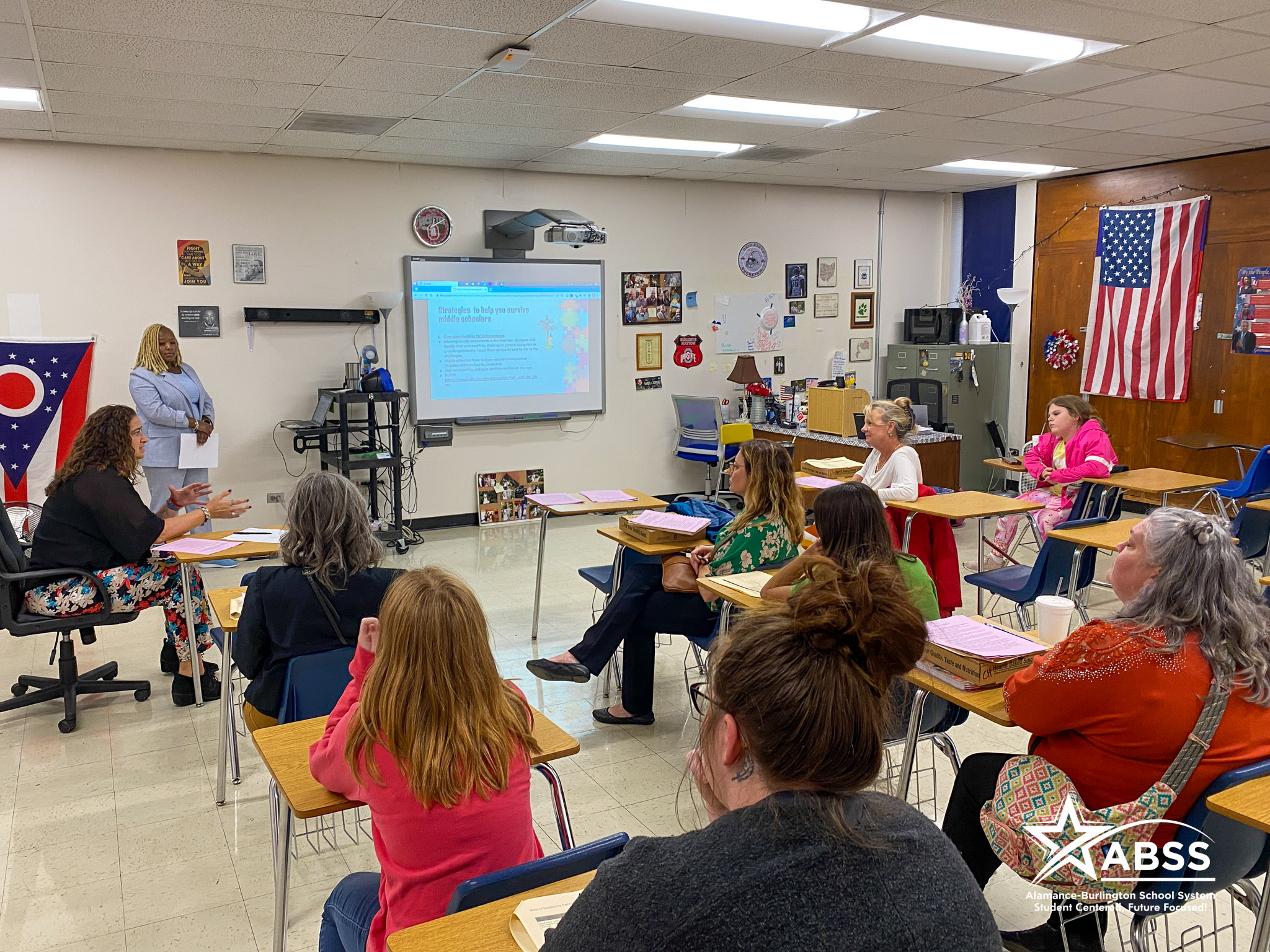ABSS staff presents to families in a classroom at Cummings High School
