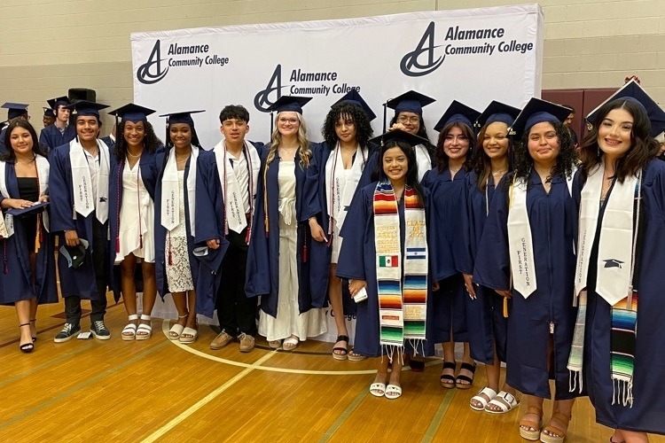 group of students on graduation day wearing traditional graduation caps and gowns