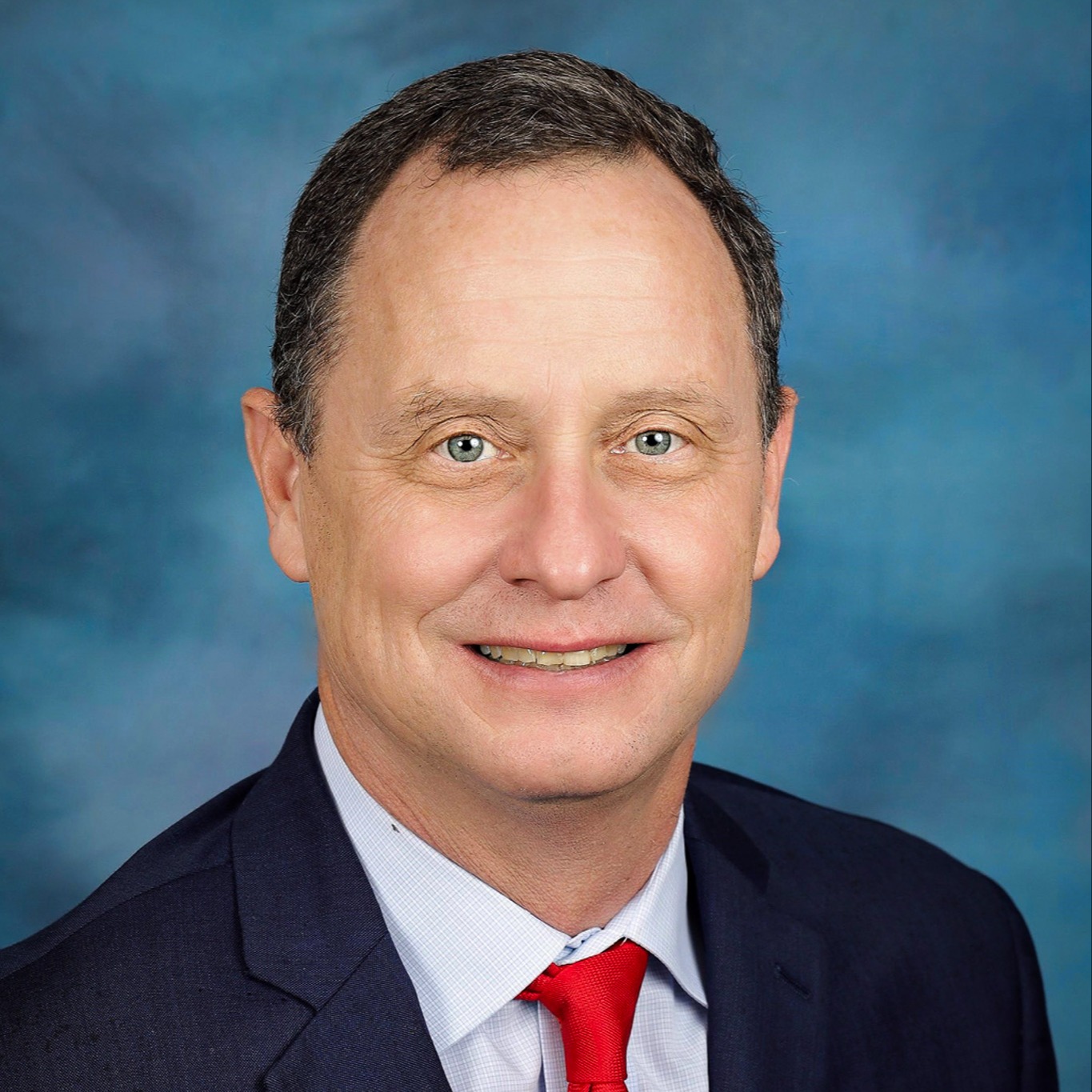 Portrait of ABSS Board Member Avery Wagoner wearing a blue suit