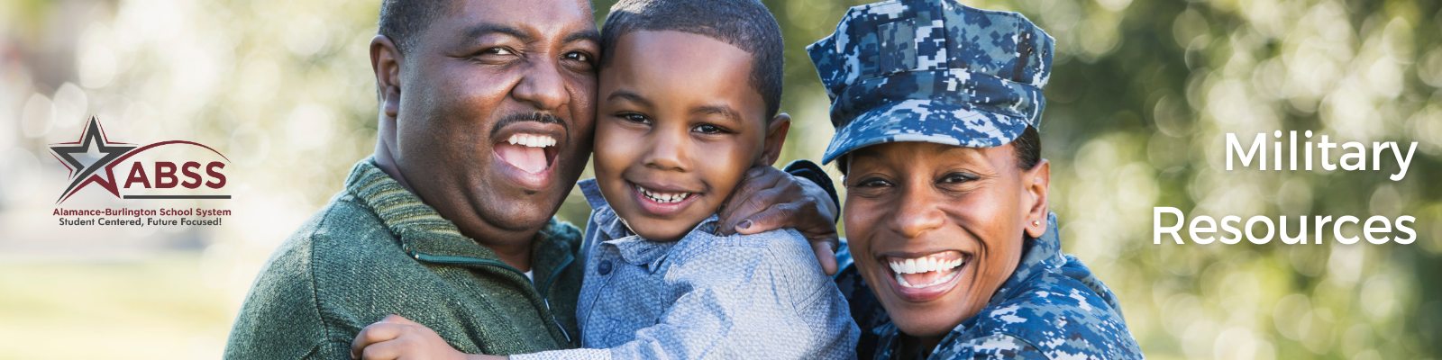 Photograph of a family holding a young boy in their arms, the woman is wearing military outfit