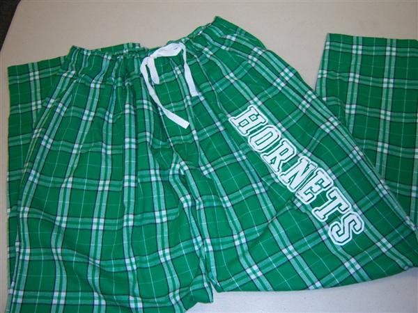 green and white plaid pajama pants with white letters of hornets down left leg
