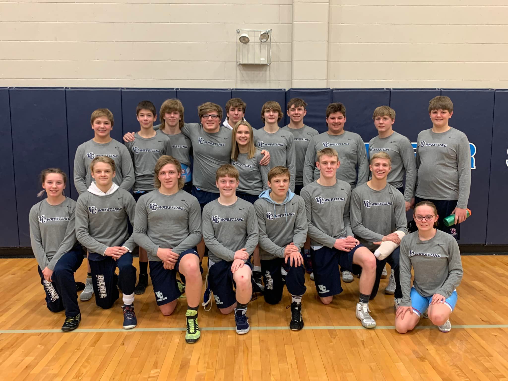Wrestling team posing in matching t-shirts