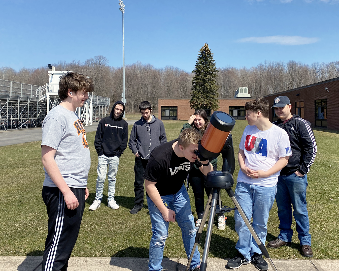 Students look through a telescope