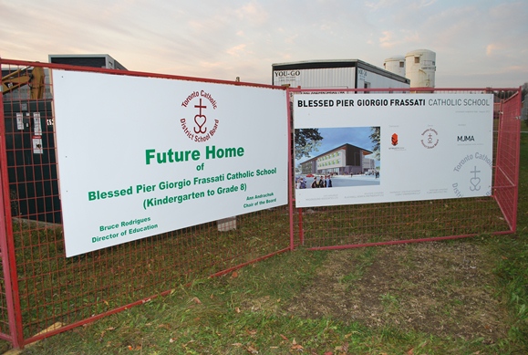 Photo of the construction site that would eventually become the school.  Sign saying "Future Home"