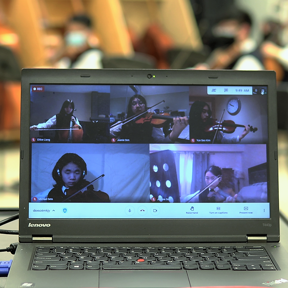 A group of students playing string instruments virtually.