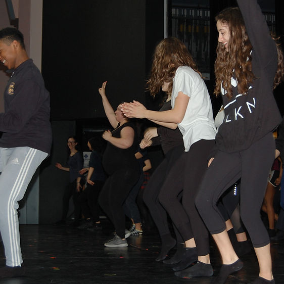 A group of students acting on stage.