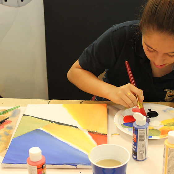 A student painting a picture.