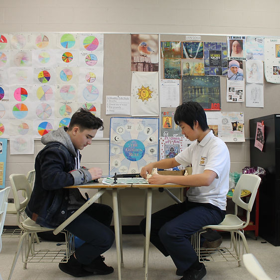 2 male students rehearsing in a classrom.