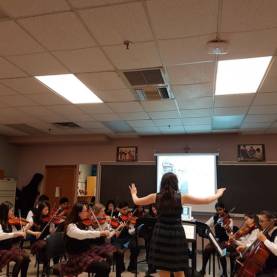 A band is rehearsing in a classroom.