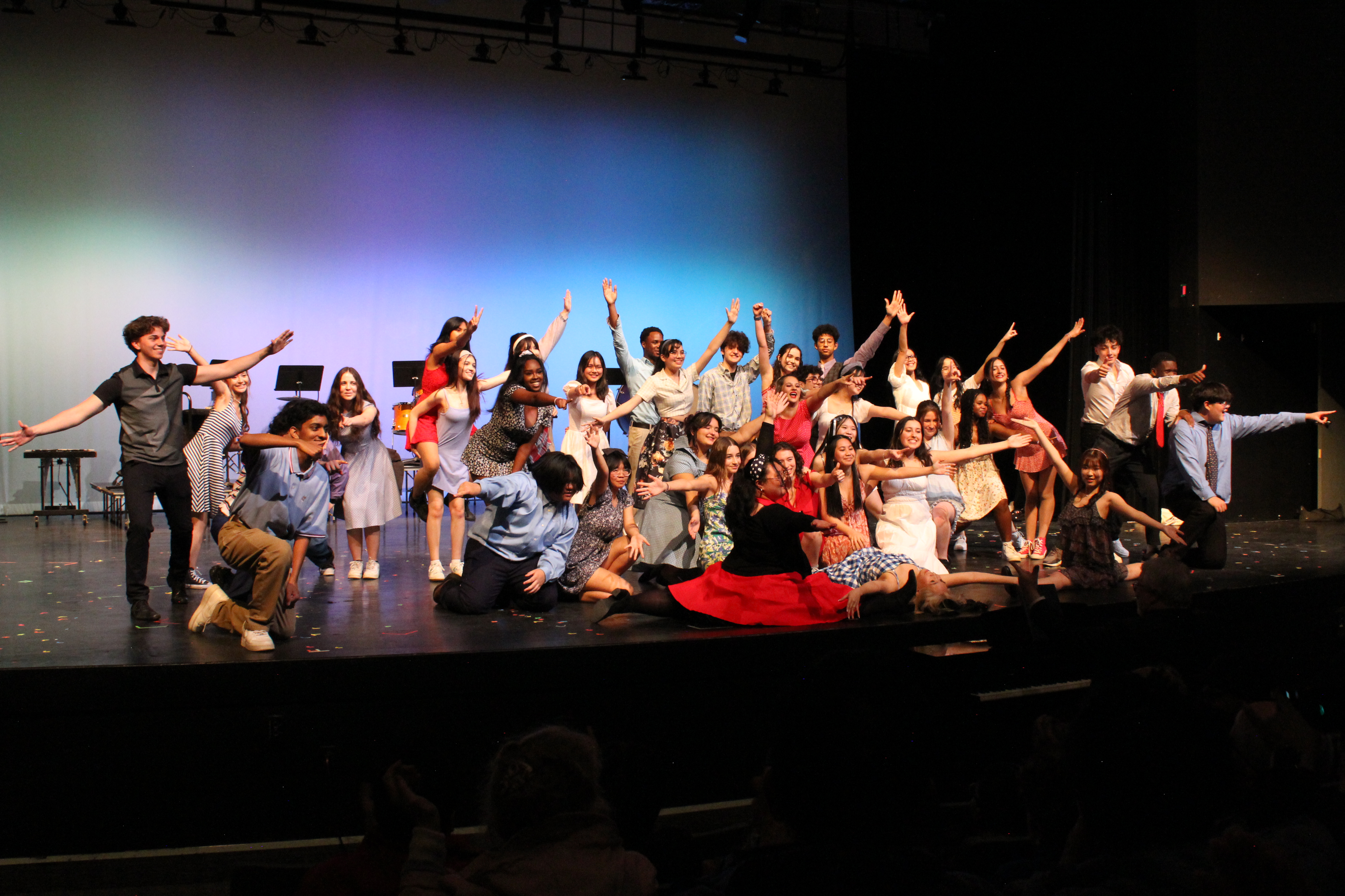 Dancers posing on stage.