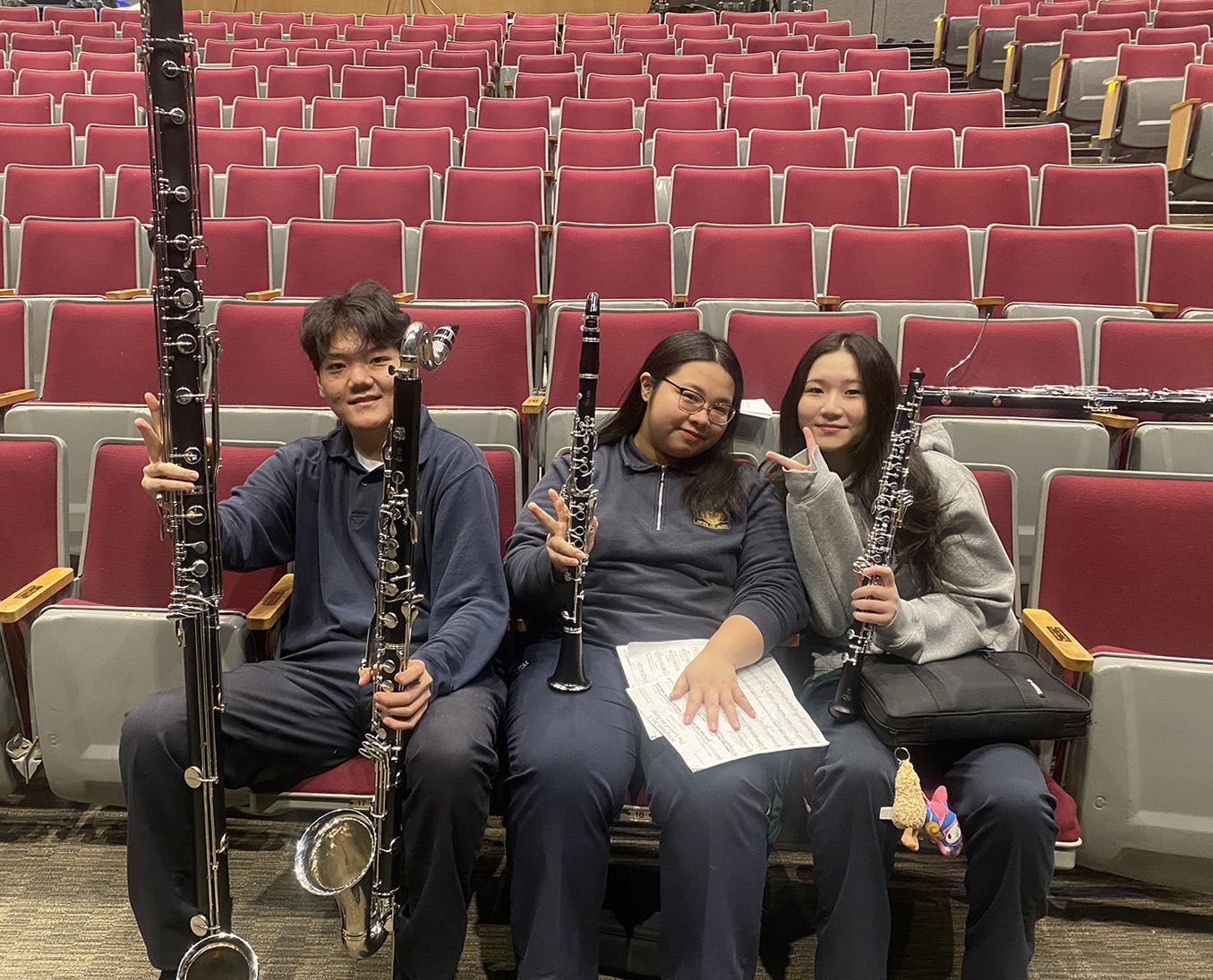 Photo of three band students with their instruments