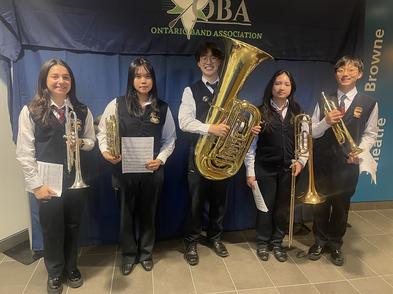 Photo of five band students with their instruments