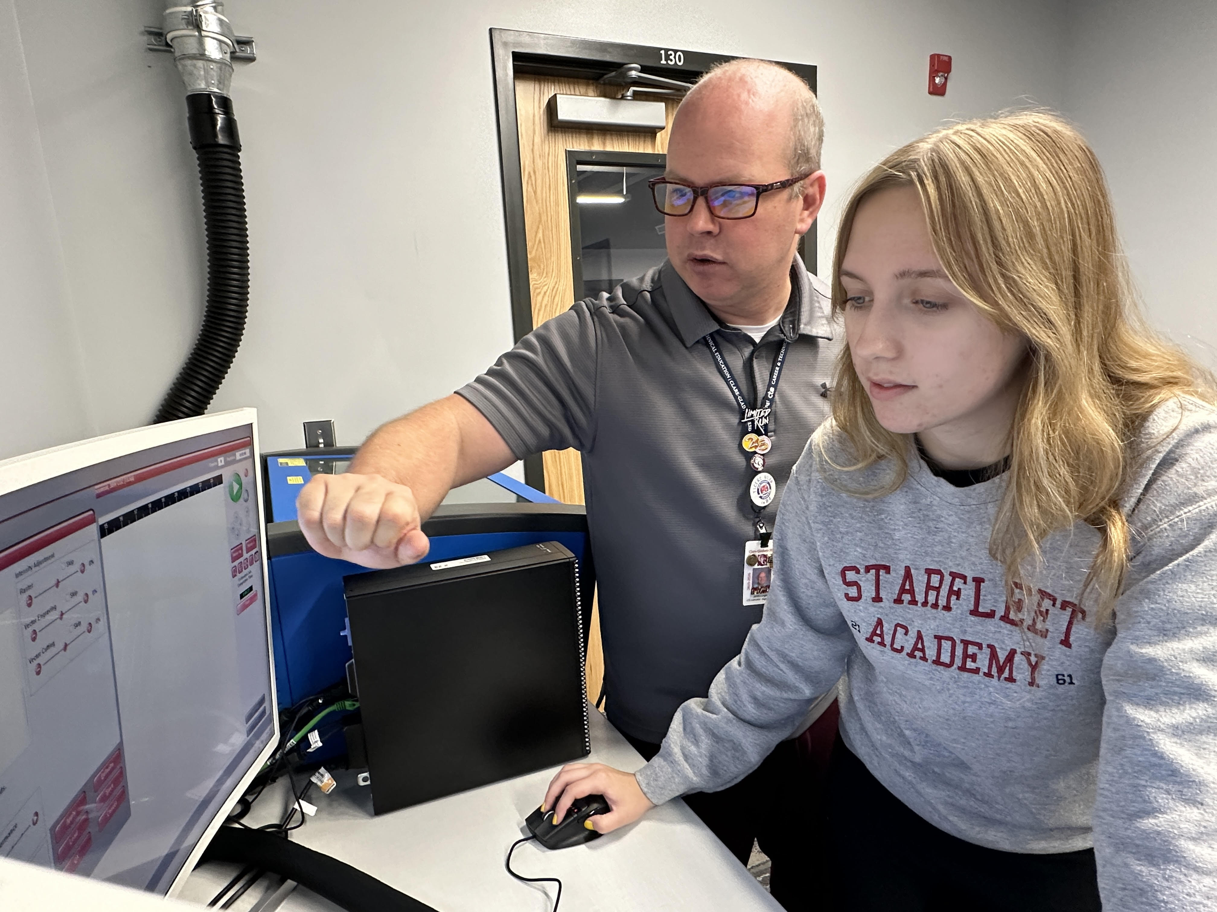 Digital Media Teacher Instructing Student