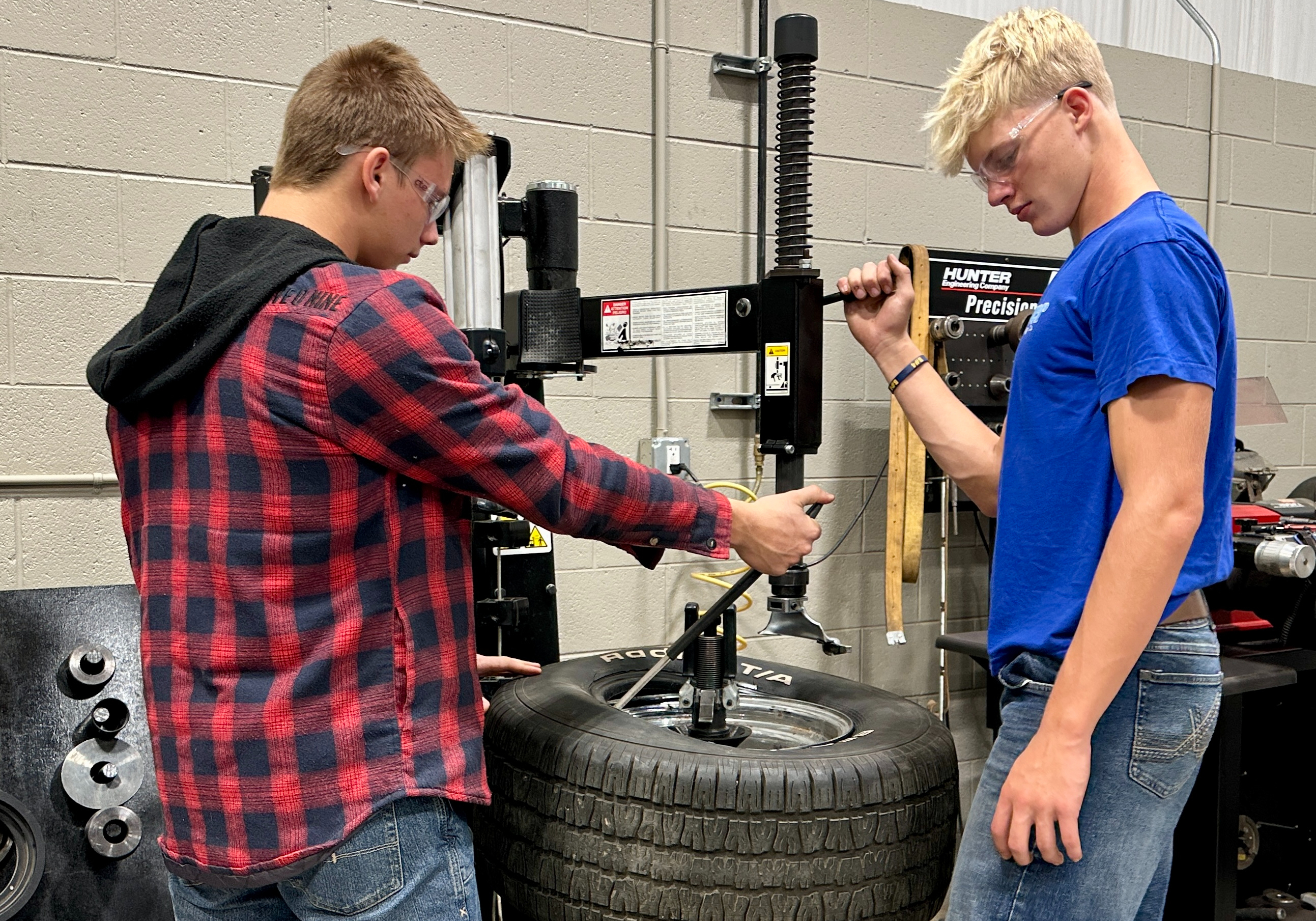 Auto students working on tire