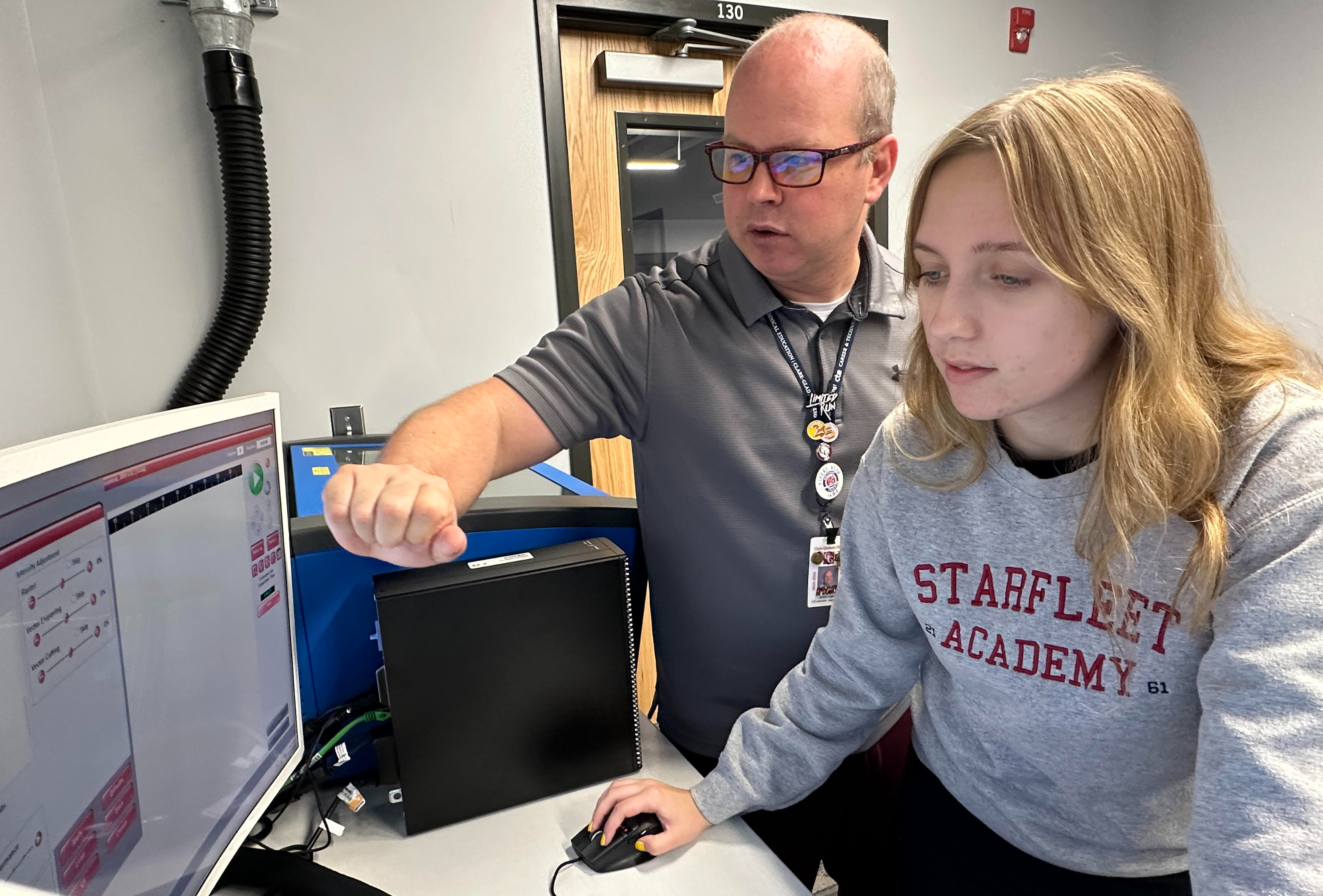 Digital Media Teacher Instructing Student