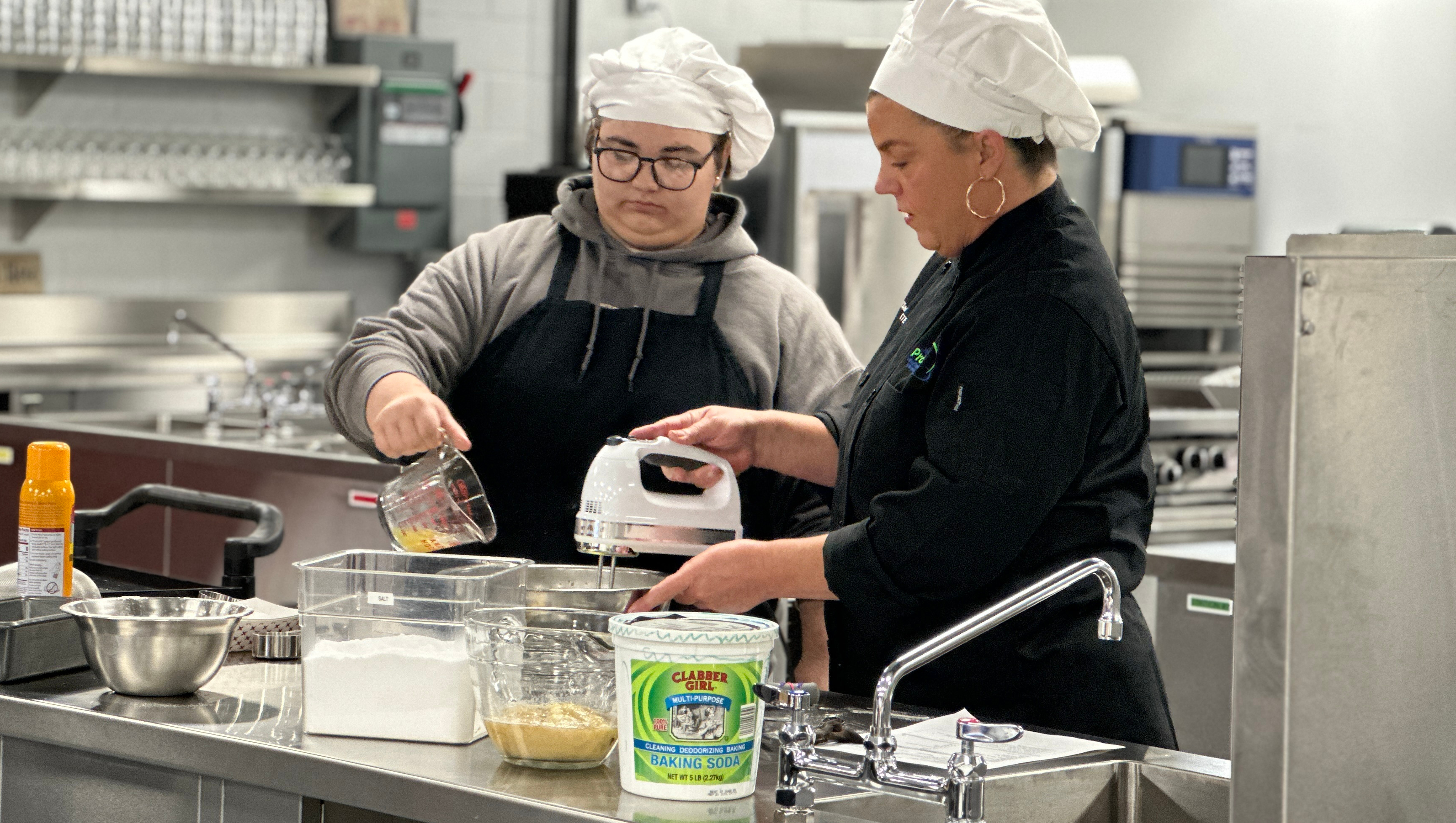 Culinary Student making banana bread with instructor