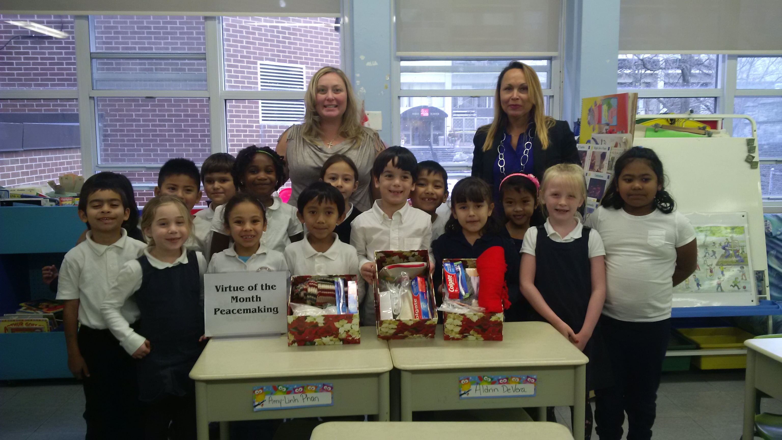 Two teachers and a group of students posing for photo at a classroom