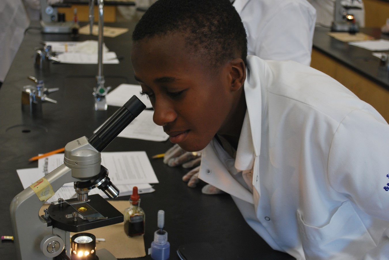 Student looking into a microscope