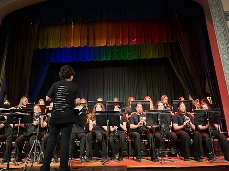 Students on stage performing in a band 