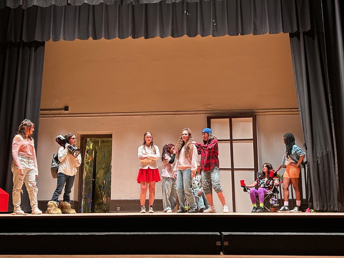 Students on stage performing in a play