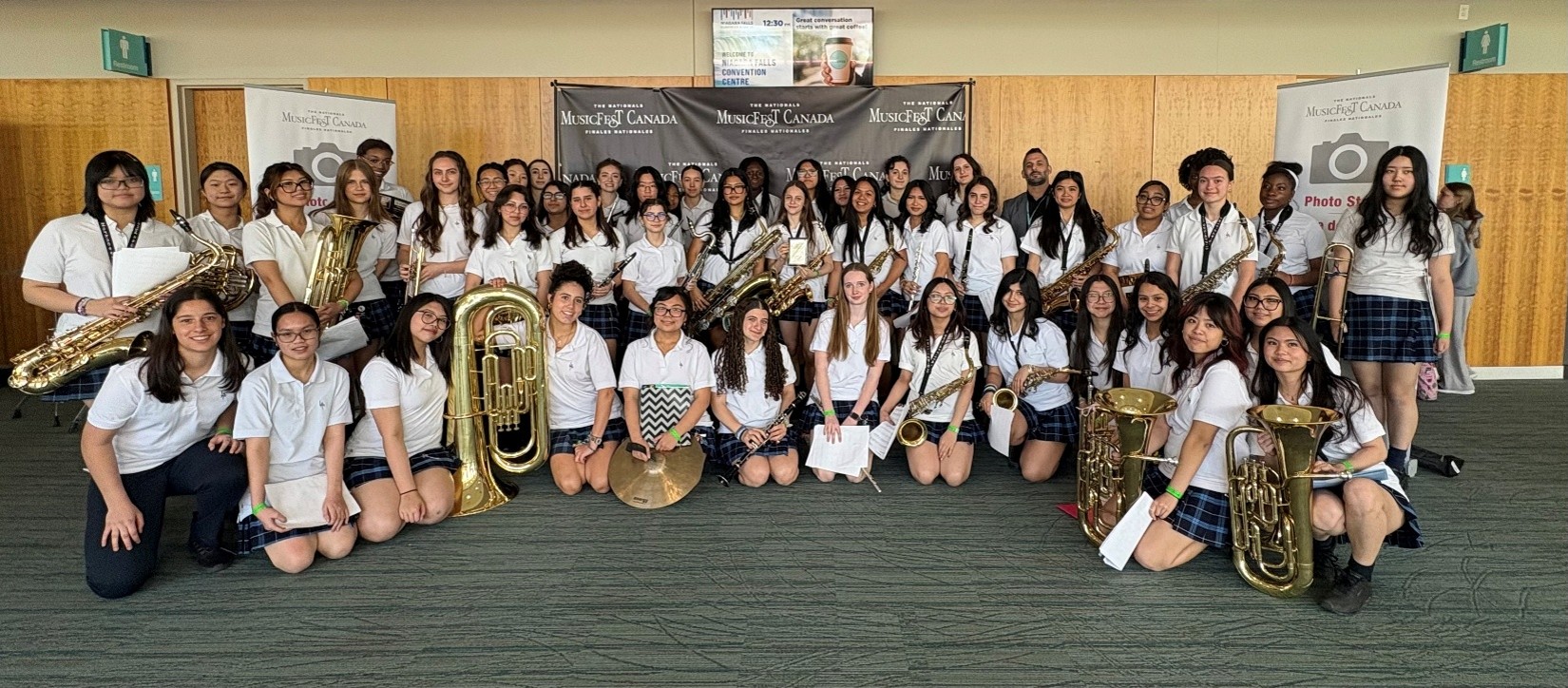 Members of a school concert band pose for a group photo with their instruments at the MusicFest Canada National Finals..