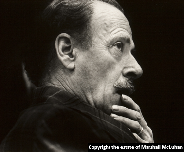 An image of Marshall McLuhan holding his hand near his face.