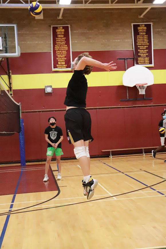 Senior boys volleyball team playing in the gym