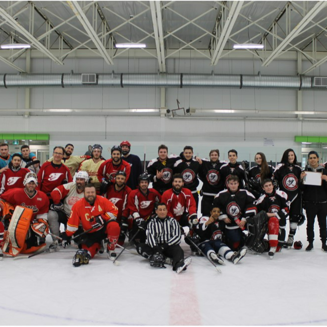 MPJ Hockey team group photo on ice rink