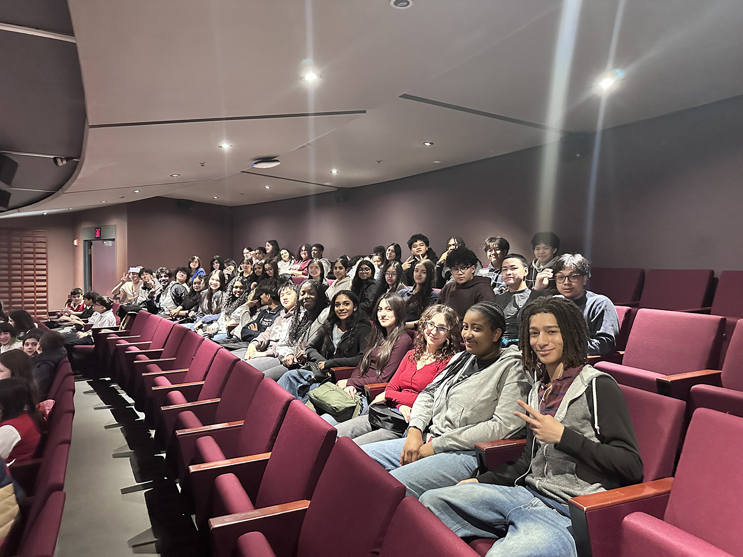Photo of students sitting together in theatre seats during a theatre outing