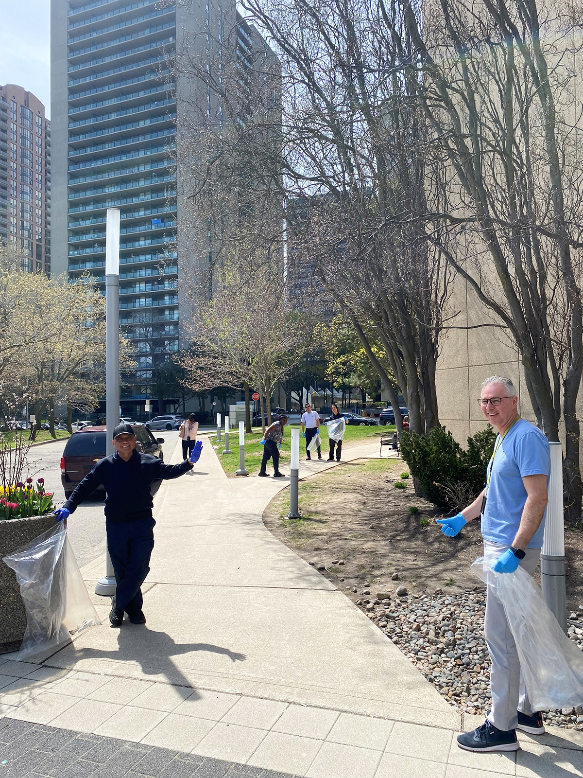 (Catholic Education Center) staff cleaning up the area in front of the CEC office building.