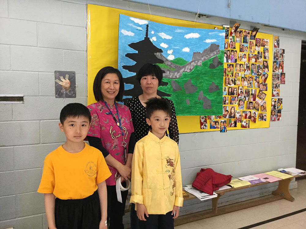 Two children and two adults standing together at an Asian Canadian Heritage month event.