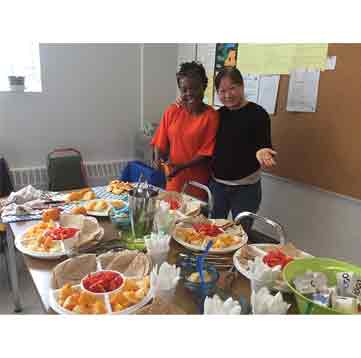 Volunteers presenting table of food