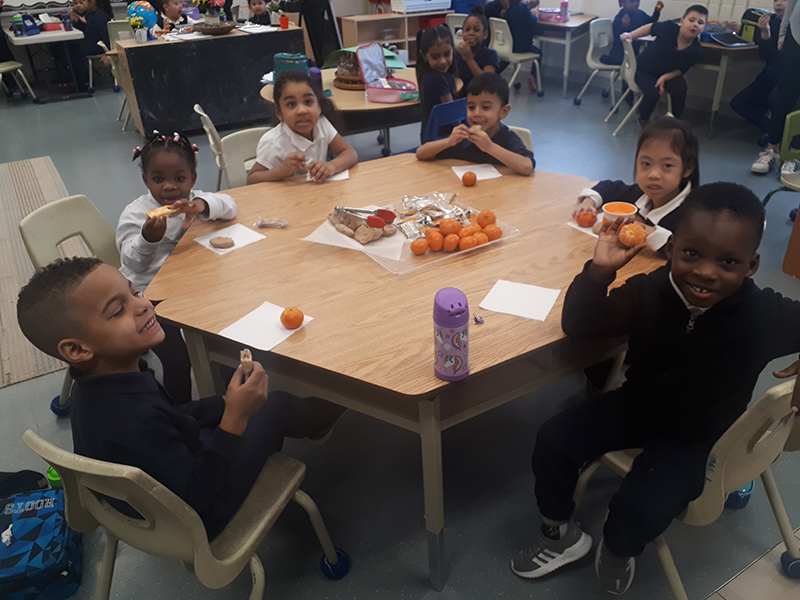 Students sitting around a table enjoying food
