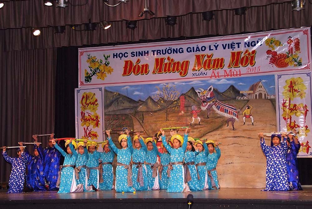 Students dressed in traditional clothing and performing on stage for the Chinese Lunar New Year